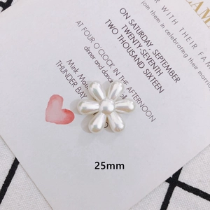 Detailed view of a 25mm cream pearl flower charm for DIY jewelry and hair accessories