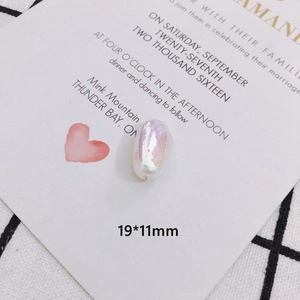 Close-up of a 19x11mm pearlescent irregular faux pearl bead with iridescent finish