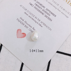 Macro shot of a 14x11mm white baroque pearl bead with a lustrous iridescent finish