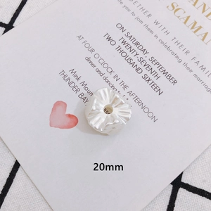 Detailed macro view of a 20mm white pleated resin flower bead for DIY jewelry making