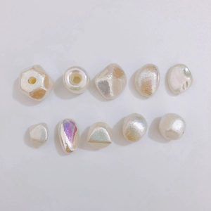 Detailed view of iridescent white baroque imitation pearls for DIY jewelry craft