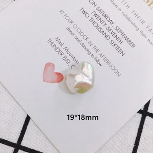 Macro view of a 19x18mm iridescent white baroque pearl bow charm for DIY jewelry making