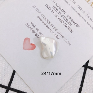Macro shot of 24x17mm baroque faux pearl charm with bow detail for DIY jewelry making