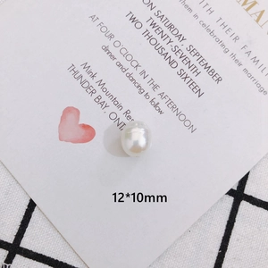 Macro shot of 12x10mm baroque pearl bead showing smooth white luster and oval shape