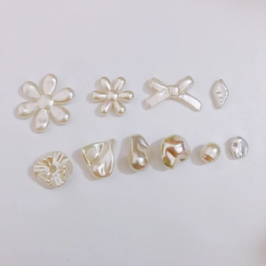 Iridescent cream white faux pearl charms in assorted floral and bow shapes for DIY jewelry