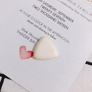 Macro view of a triangular off-white resin cabochon for DIY phone case accessories