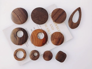Macro shot of dark wood geometric charms for DIY earring making with natural textures
