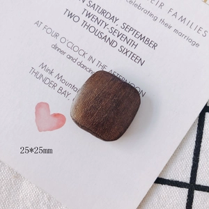 Macro detail of square brown walnut wood jewelry accessories with 25mm dimensions
