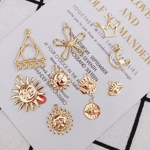 Golden sun and moon charms for DIY jewelry making with celestial embossed patterns