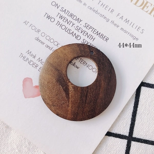 Macro detail of a 44mm brown geometric round wooden pendant for DIY jewelry making