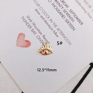 Macro shot of 12.5x11mm gold-plated eye-shaped alloy charm with closed loop for DIY jewelry