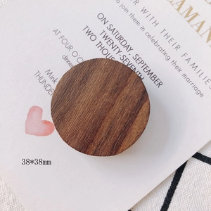 Macro detail of 38mm round dark brown natural wood accessories with clear grain texture