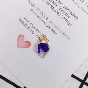 Close-up of geometric purple gradient acrylic pendant with gold textured metal rim