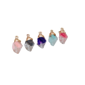 Five irregular natural crystal pendants with gold edges and hooks in various vibrant colors