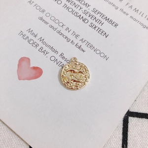 Macro shot of 18K gold plated vintage coin pendant with relief horse design and rope border