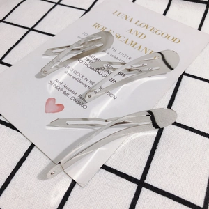 Three silver teardrop metal BB hair clips on minimalist plaid background and card