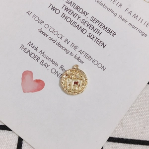 Macro view of 18K gold plated Taurus zodiac coin pendant with relief engraving