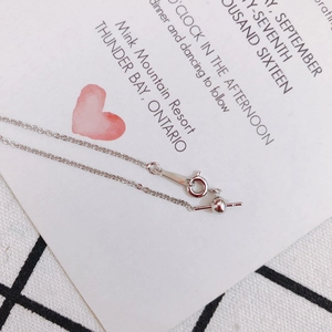 Detail of adjustable silver chain with ball slider and needle pin connector on gift card
