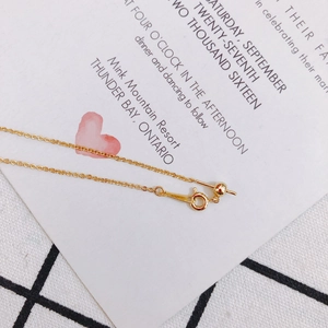 Detail of adjustable gold O-chain bracelet with slider bead and spring clasp closure