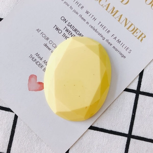 Gros plan d'une breloque ovale géométrique jaune en résine pour accessoires cheveux