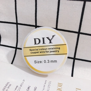 Detailed close-up of 0.3mm jewelry copper wire on a white spool for DIY crafting