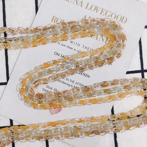 Macro detail of amber and transparent resin chain links for DIY jewelry making