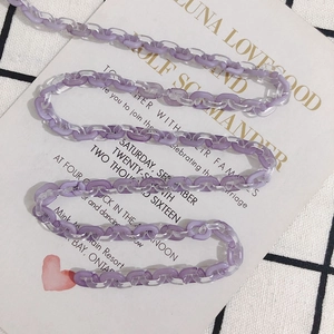 Macro detail of purple and clear acetate chain links for DIY accessory jewelry making