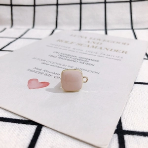 Detail of pink square pendant with gold rim and metal loop for DIY jewelry making