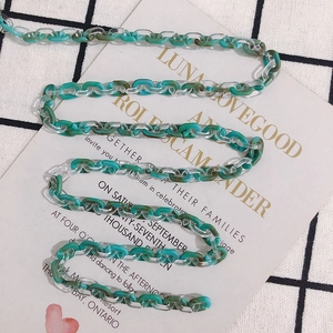 Detailed view of green marble and clear acrylic hollow links for jewelry making
