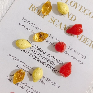 DIY fruit charms including red strawberry and yellow lemon beads for jewelry making