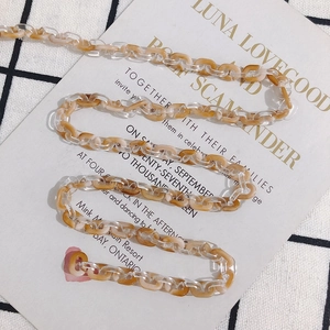 Detail view of amber and clear acrylic chain links for DIY jewelry and accessories