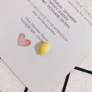 Close-up of a mini resin lemon bead with side hole for DIY jewelry making and crafts