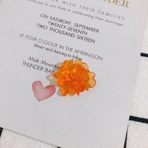 Macro detail of translucent orange resin flower component for DIY earrings and jewelry