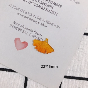 Macro shot of yellow resin ginkgo leaf charm for DIY jewelry making with dimensions 22x15mm