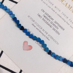 Macro shot of 6x2mm heart-shaped blue metallic hematite beads for DIY jewelry making