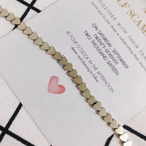 Detailed view of polished golden heart-shaped beads for DIY jewelry and beaded crafts