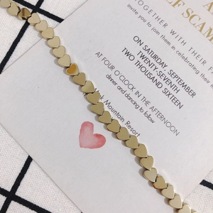Close-up of polished gold heart-shaped bead chain with reflective metallic finish