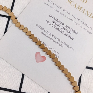 Close-up of golden matte heart-shaped chain links for jewelry making and DIY projects