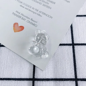 Macro shot of faceted clear acrylic bear pendant with light-reflecting crystal surfaces