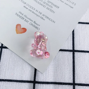 Macro shot of pink aurora acrylic bear pendant with iridescent finish for DIY jewelry