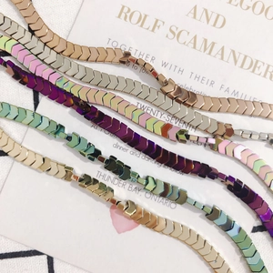 Close-up of arrow-shaped hematite beads in multiple plating colors for DIY jewelry making