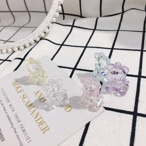 Transparent faceted acrylic bear pendants in assorted pastel colors on plaid background