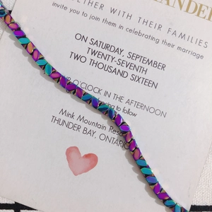 Macro view of iridescent faceted hematite beads with a metallic aurora oil-slick finish