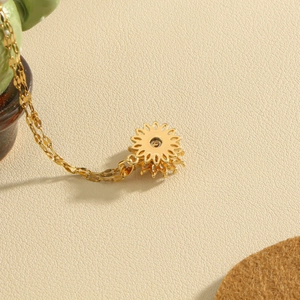 Collana in acciaio dorato con ciondolo a girasole rotante in zircone su pelle beige