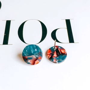 Detail of colorful marble pattern resin stud earrings showing metal post back and texture