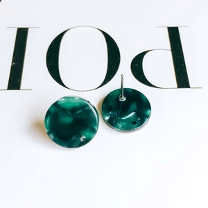 Close-up of green marble acetate round earrings with silver pins for DIY jewelry