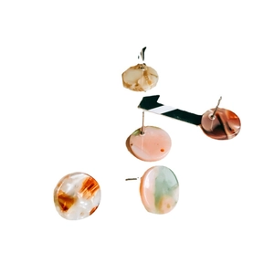 DIY acetate resin round stud earrings with marble and tortoiseshell patterns on white background
