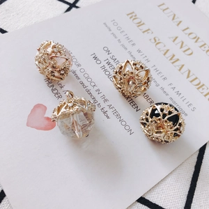 Detail of vintage hollow alloy pearl charms with crystals in pink, white and black