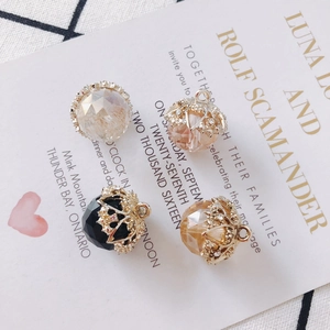 Detail of faceted crystal pendants with ornate gold caps for DIY jewelry making