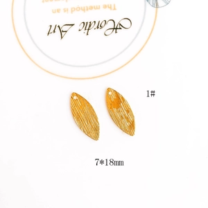 Detail view of gold leaf pendant with vertical texture and 7x18mm size for DIY jewelry